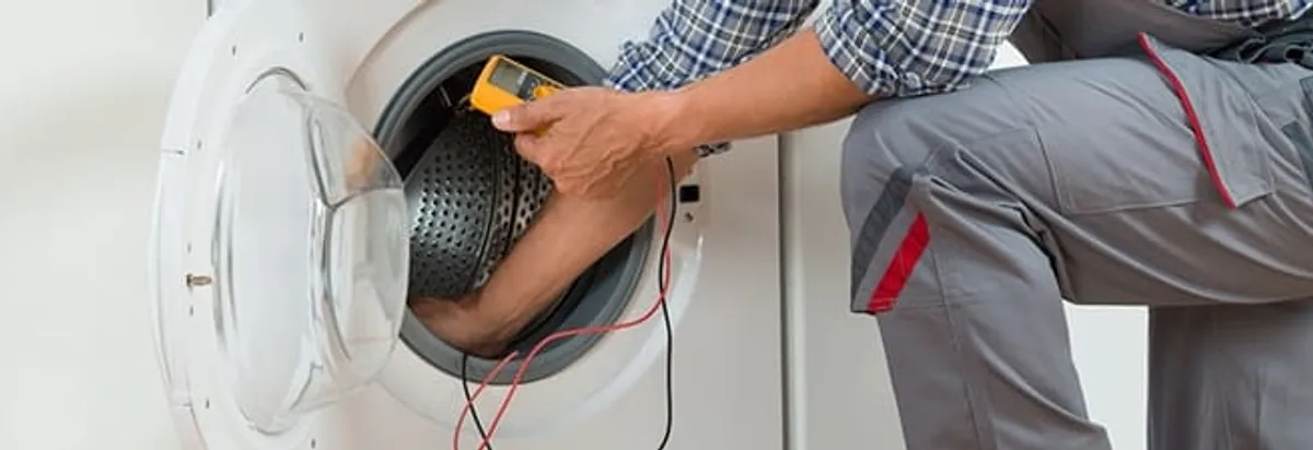 Dryer repair technician inspecting and repairing a clothes dryer in Cape Coral, FL
