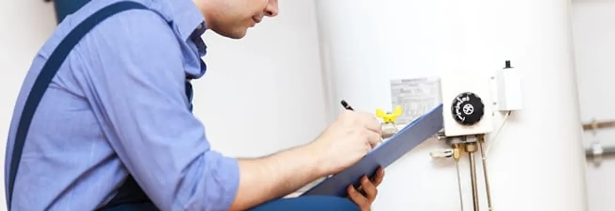 Water heater repair technician inspecting the unit and recording service notes in Cape Coral, FL