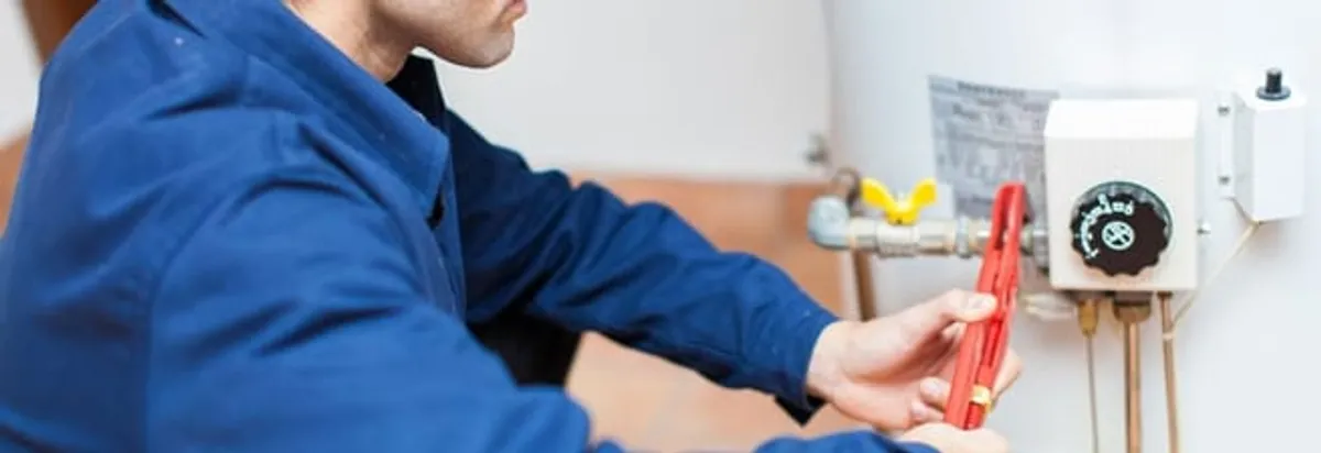 Water heater repair technician adjusting the temperature control and gas valve in Cape Coral, FL